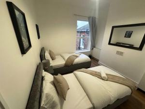 a room with two beds and a window at Cosy Apartment in London in London