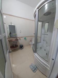 a bathroom with a shower and a sink and a toilet at Đất Cảng Homestay in Hai Phong