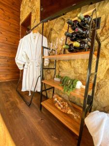 a room with a shelf with bottles of wine at Recanto Entre Rios in Bom Jardim da Serra