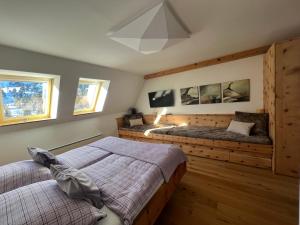 a bedroom with two beds and a flat screen tv at TurrachART in Turracher Hohe