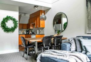 a kitchen and dining room with a table and chairs at The Eden Whistler - Luxury 2 BDRM Ski in / Ski out in Whistler