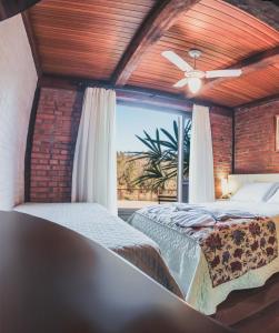 1 dormitorio con 2 camas y ventilador de techo en Pousada LindnerHof, en Rio dos Cedros