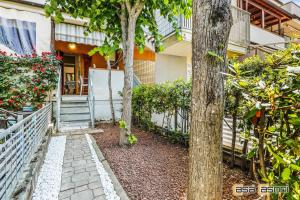 a walkway in front of a house with trees at Casa Casoni mare a 100m dalla spiaggia in Numana