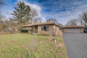 a house with a driveway in front of a yard at Cozy Lisle Home with Fenced Backyard Pets Welcome! in Lisle