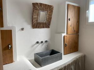 a bathroom with a sink and a mirror at Villa Xanthos in Plaka +69 photos
