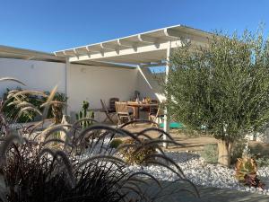 a patio with a table and chairs under a pergola at Villa Xanthos in Plaka