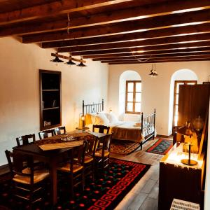 a living room with a table and chairs and a bed at Kristi's Homes - ''Traditional Home'' in Dimitsana in Dhimitsana