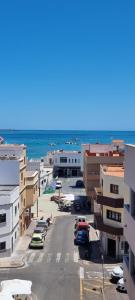 an aerial view of a city with the ocean at Luxury Penthouse Valentin with jacuzzi in Corralejo