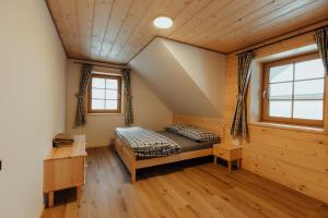 a bedroom in a log cabin with a bed at Chata pod Mníchom in Terchová