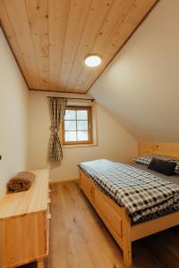 a bedroom with a bed and a window at Chata pod Mníchom in Terchová