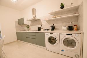 a kitchen with a washing machine and a sink at A Due Passi in Montesano Scalo