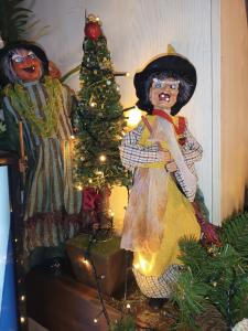 two dolls are standing next to a christmas tree at Villa Barone in Selva di Fasano