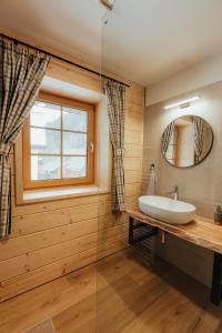 a bathroom with a sink and a mirror at Chata pod Mníchom in Terchová