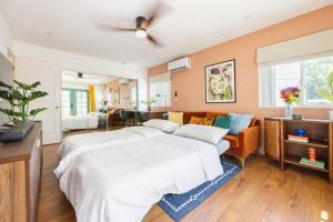 a large bedroom with two beds and a couch at Emerald Guest House in San Diego