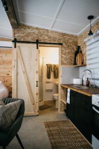 a bathroom with a sliding barn door and a toilet at Le 2800 du Parc in Shawinigan