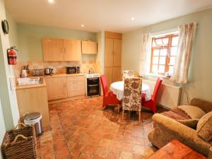 a kitchen with a table and chairs and a table and a room at Ratty's Retreat in Spilsby