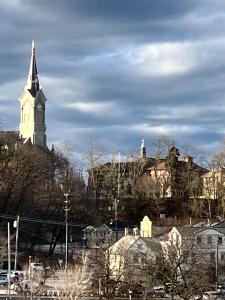 a church steeple with a clock tower in a city at The Port Hotel in Port Washington