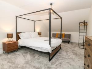 a bedroom with a four poster bed with a canopy at White Bull House in Amlwch