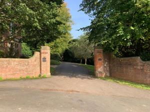 a brick wall with two entrances to a road at The Hideaway in Lyme Regis