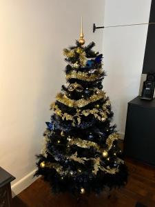 a christmas tree with blue and gold decorations at GITADIN - Deluxe Suite Valens - Historical Center in Liège