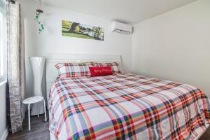 um quarto com uma cama com um cobertor xadrez colorido em Spacious and Private Tampa Retreat condo em Tampa