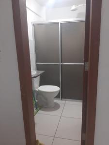 a bathroom with a toilet and a shower stall at Flat Amarração 130 in Luis Correia