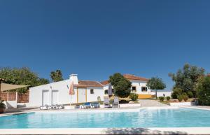 a villa with a swimming pool and a house at Country House - Quinta das 3 Nogueiras in Abitureiras