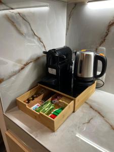 a coffee maker sitting on top of a wooden tray at ADOUNIA HOME in Naples