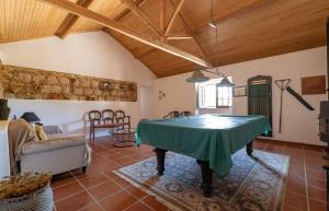 a living room with a ping pong table at Country House - Quinta das 3 Nogueiras in Abitureiras