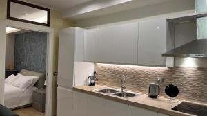 a kitchen with a sink and a bed in a room at Loft San Leopardo in Rieti