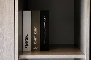 two books sitting on a shelf in a cabinet at Finnieston Apartment in Glasgow