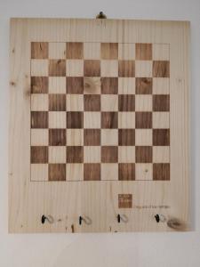 a wooden chessboard on a wall with at Dimora La Turrita in Bologna