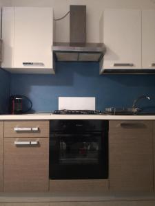 a kitchen with a stove top oven in a kitchen at Dimora La Turrita in Bologna