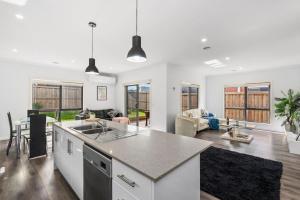 a kitchen and living room with a counter top at Nirvana Armstrong Creek Family Beach Home in Mount Duneed