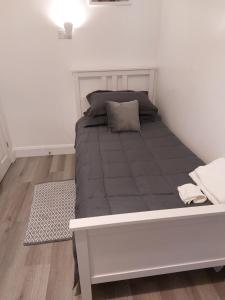 a bed in a white room with a mattress at De lick strawberry studio in London