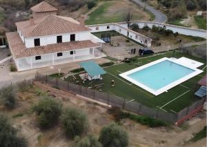 an aerial view of a house with a swimming pool at Caminito del Rey Piscina Campo fútbol 20 adultos in Alora