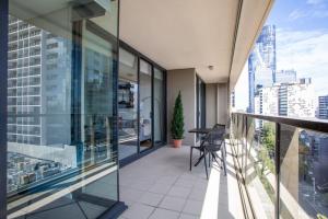 an apartment balcony with a view of a city at Sapphire of South Yarra - two bedroom condominium in Melbourne