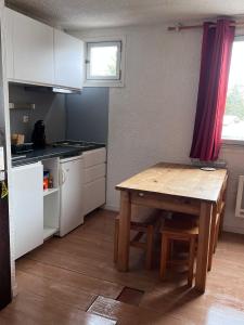 レ・デュー・アルプにあるT2 cosy, pieds des pistes 4 pers. centre stationの小さなキッチン(木製テーブル、テーブル、椅子付)