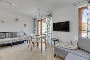 a living room with a table and a couch at STEGNA PARK C Apartamenty Piamola WiFi in Stegna