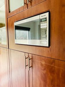 eine Mikrowelle auf einem Holzschrank in einer Küche in der Unterkunft Homestay- private room and bathroom in Whitby