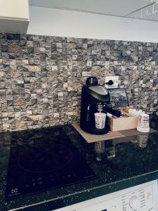 a kitchen counter with a coffee maker on a counter top at GataBagajul Apartments - Vaslui in Vaslui +15 photos