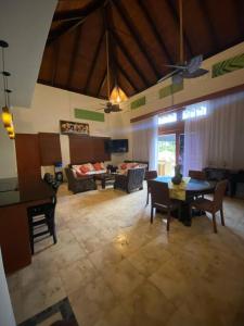 a large living room with a table and chairs at Luxury private village Cap Cana in Punta Cana