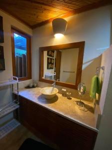 a bathroom with a sink and a large mirror at Luxury private village Cap Cana in Punta Cana