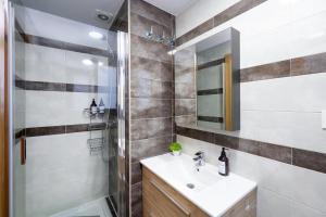 a bathroom with a sink and a shower at Grace Apartments - 3 bedroom City Centre in Granada