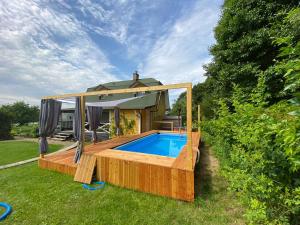 a house with a swimming pool in the yard at Agroturystyka Siedlisko in Lubowidz