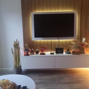 a living room with a television on a white cabinet at Apartman Prodan in Sombor