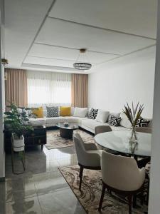 a living room with a couch and a table at Harhoura Modern Flat in Temara