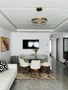a living room with a table and chairs at Harhoura Modern Flat in Temara