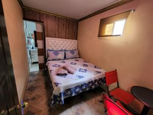 a small bedroom with a bed and a mirror at Hotel La Pampa in Alto Hospicio