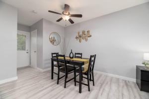 a dining room with a table and a ceiling fan at Just Off Wilton Drive Apt 5 in Fort Lauderdale